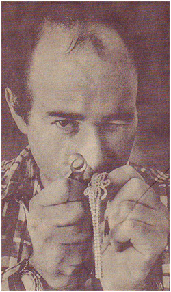Jeweler inspecting a strand of pearls through a loupe.
